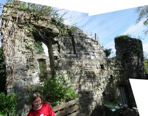 Abigail sitting infront of a ruined building in the churchyard